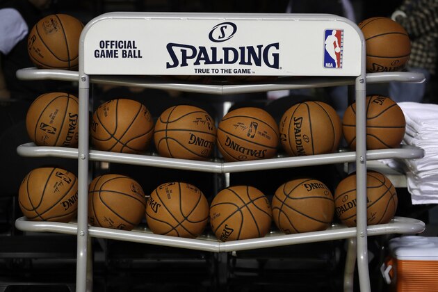 FILE - In this Dec. 6, 2017, file photo, basketballs sit in a rack on the court during a training session by the Brooklyn Nets at the Mexico City Arena in Mexico City. The four major pro sports leagues and the NCAA think that expanding legal betting  will lead to more game-fixing. The architects of New Jersey’s successful legal challenge to the sports gambling ban say those fears are overstated and that bringing sports betting out of the shadows will make it easier to detect illegal activity. (AP Photo/Rebecca Blackwell, File)