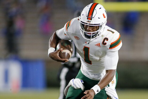 Miami quarterback D'Eriq King (1) fights for yards as he is tackled by Duke safety Jaylen Stinson (16) during the second half of an NCAA college football game Saturday, Dec. 5, 2020, in Durham, N.C. (Nell Redmond/Pool Photo via AP)
