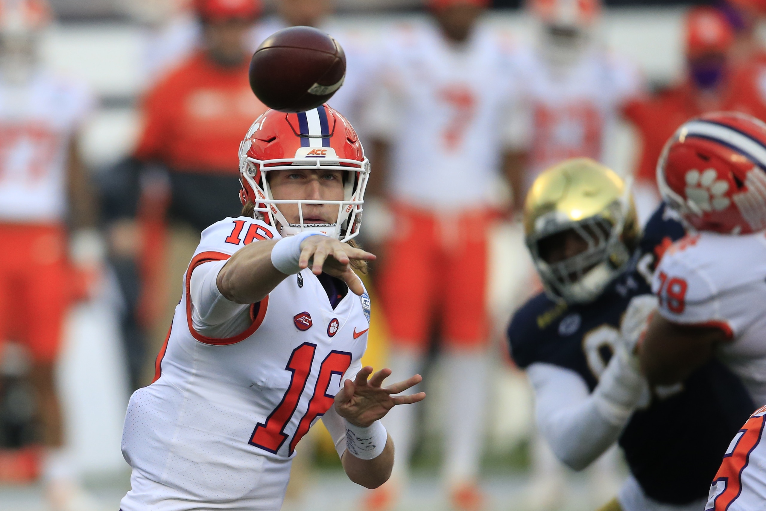 FILE - In this Saturday, Dec. 19, 2020, file photo, Clemson quarterback Trevor Lawrence (16) throws to an open receiver during the first half of the Atlantic Coast Conference championship NCAA college football game against Notre Dame in Charlotte, N.C. Lawrence has been named a finalist for the Heisman Trophy. The Heisman will be awarded Jan. 5 during a virtual ceremony as the pandemic forced the cancellation of the usual trip to New York that for the presentation that usually comes with being a finalist.  (AP Photo/Brian Blanco, File)