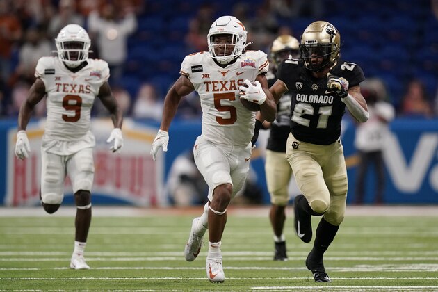 Texas running back Bijan Robinson (5) carries during the first half against Colorado in the Alamo Bowl NCAA college football game Tuesday, Dec. 29, 2020, in San Antonio. (AP Photo/Eric Gay)