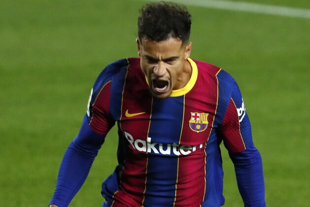 Barcelona's Philippe Coutinho celebrates scoring the opening goal during the Spanish La Liga soccer match between FC Barcelona and Sevilla FC at the Camp Nou stadium in Barcelona, Spain, Sunday, Oct. 4, 2020. (AP Photo/Joan Monfort)