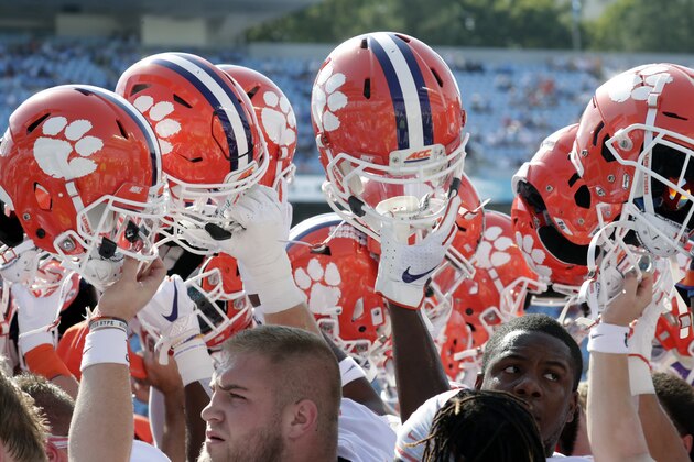 The Clemson team raises its helmets in a rally cry at the conclusion of warm-ups before an NCAA college football game against North Carolina in Chapel Hill, N.C., Saturday, Sept. 28, 2019. (AP Photo/Chris Seward)