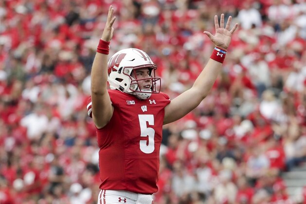 FILE - In this Sept. 7, 2019, file photoWisconsin's Graham Mertz reacts to a touchdown during the second half of an NCAA college football game against Central Michigan in Madison, Wis. Mertz is about to get his chance to show he’s worthy of all the acclaim that accompanied his arrival on campus last year. Now that foot surgery has sidelined returning starter Jack Coan indefinitely, Mertz is likely to open the season as the 16th-ranked Badgers’ first-team quarterback. (AP Photo/Morry Gash, File)