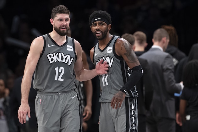 Brooklyn Nets forward Joe Harris (12) and guard Kyrie Irving (11) talks during a break in action in the second half of an NBA basketball game against the New Orleans Pelicans, Monday, Nov. 4, 2019, in New York. The Nets won 135-125. (AP Photo/Mary Altaffer)