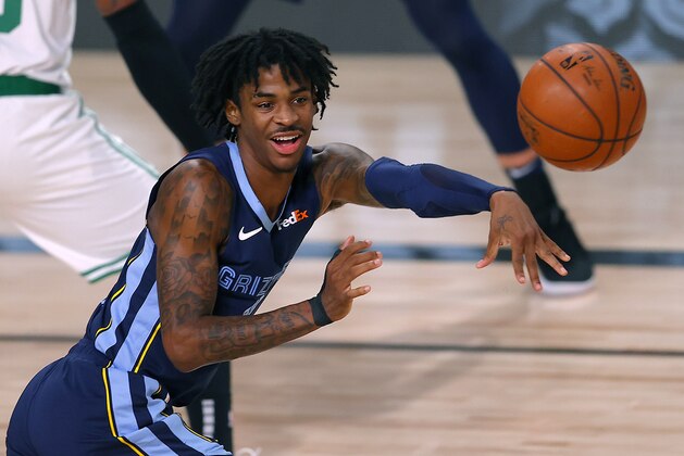 FILE - In this Aug. 11, 2020, file photo, Memphis Grizzlies' Ja Morant passes the ball during the second half of an NBA basketball game against the Boston Celtics in Lake Buena Vista, Fla. Morant and the Grizzlies once again seem to be an afterthought heading into the NBA season. Morant says proving everyone wrong again about him and his teammates is his top goal. (AP Photo/Mike Ehrmann, Pool, File)