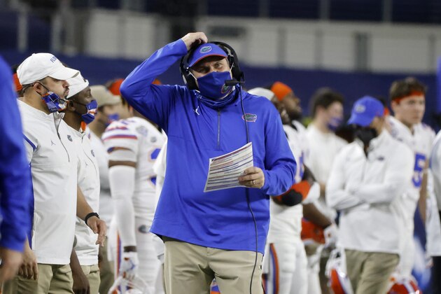 Florida head coach Dan Mullen, center, watches play against Oklahoma in the first half of the Cotton Bowl NCAA college football game in Arlington, Texas, Wednesday, Dec. 30, 2020.(AP Photo/Michael Ainsworth)