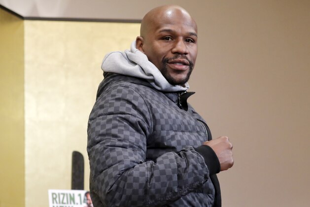 Floyd Mayweather Jr. poses for photographers during a news conference in Tokyo Saturday, Dec. 29, 2018. Mayweather is scheduled to fight Japanese kickboxer Tenshin Nasukawa in a three-round exhibition match in Japan on New Year's Eve. (AP Photo/Eugene Hoshiko)