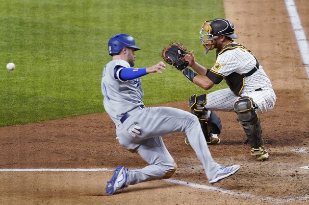 Los Angeles Dodgers' A.J. Pollock, left, beats the throw to score on a single by Joc Pederson during the third inning in Game 3 of a baseball National League Division Series Thursday, Oct. 8, 2020, in Arlington, Texas. At right is San Diego Padres catcher Jason Castro. (AP Photo/Tony Gutierrez)