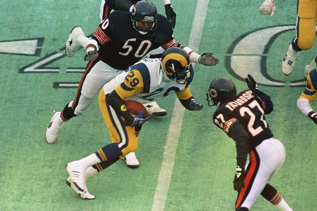 Ram's running back Eric Dickerson (29) comes up short of running room against Bears' defenders Mike Richardson (27) and Mike Singletary (50), on a second quarter carry by the Rams during the Sunday, Jan. 12, 1986 NFC battle at Chicago's Soldier Field. (AP Photo/Fred Jewell)