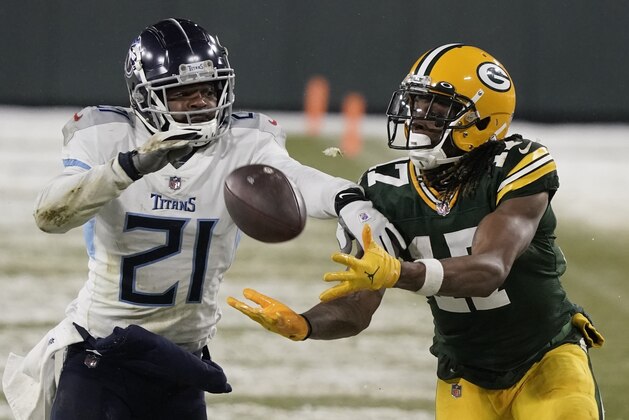Green Bay Packers' Davante Adams catches a pass in front of Tennessee Titans' Malcolm Butler during the second half of an NFL football game Sunday, Dec. 27, 2020, in Green Bay, Wis. (AP Photo/Morry Gash)