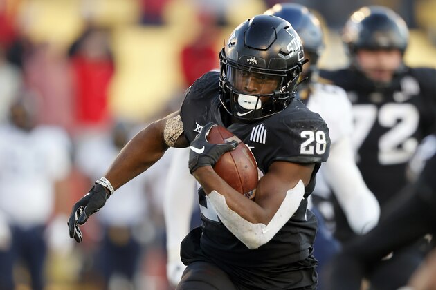 FILE - In this Dec. 5, 2020, file photo, Iowa State running back Breece Hall runs the ball against West Virginia during the first half of an NCAA college football game in Ames, Iowa. Hall was selected as the Big 12 offensive player of the year. (AP Photo/Matthew Putney, File)