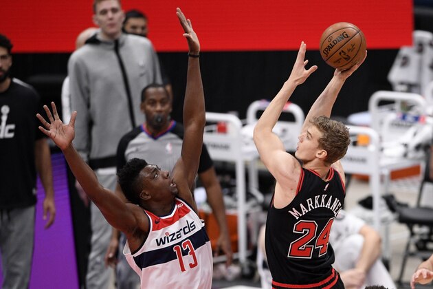 Chicago Bulls forward Lauri Markkanen (24) shoots against Washington Wizards center Thomas Bryant (13) during the first half of an NBA basketball game, Tuesday, Dec. 29, 2020, in Washington. (AP Photo/Nick Wass)