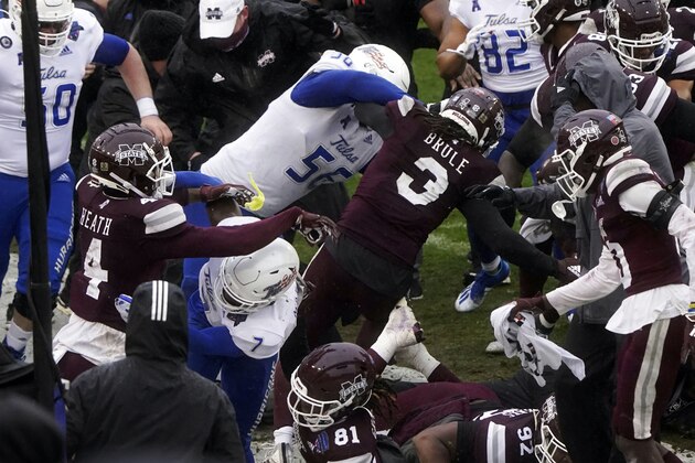 Members of Tulsa and Mississippi State fight after time runs out in the Armed Forces Bowl NCAA college football game Thursday, Dec. 31, 2020, in Fort Worth, Texas. (AP Photo/Jim Cowsert)
