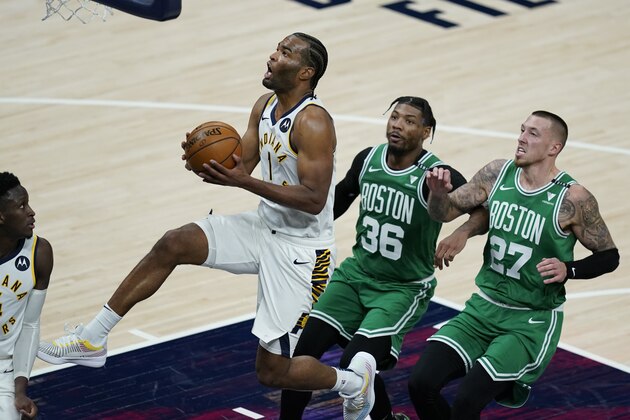 Indiana Pacers' T.J. Warren (1) goes to the basket as Boston Celtics' Marcus Smart (36) and Daniel Theis (27) trail during the second half of an NBA basketball game Tuesday, Dec. 29, 2020, in Indianapolis. (AP Photo/Darron Cummings) Indiana Pacers' T.J. Warren (1) goes to the basket as Boston Celtics' Marcus Smart (36) and Daniel Theis (27) trail during the second half of an NBA basketball game Tuesday, Dec. 29, 2020, in Indianapolis. (AP Photo/Darron Cummings)