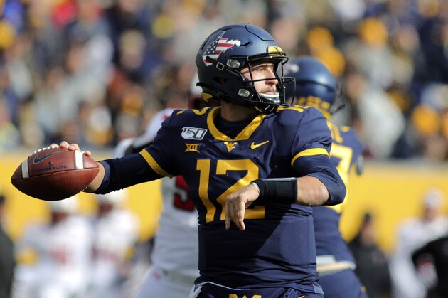 West Virginia quarterback Austin Kendall (12) looks to pass during the second quarter of their NCAA college football game against Texas Tech in Morgantown, W.Va., Saturday, Nov. 9, 2019. (AP Photo/Chris Jackson)