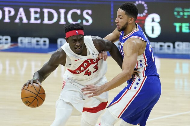 Toronto Raptors' Pascal Siakam, left, tries to get past Philadelphia 76ers' Ben Simmons during the first half of an NBA basketball game, Tuesday, Dec. 29, 2020, in Philadelphia. (AP Photo/Matt Slocum)