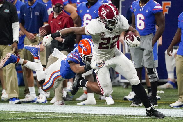 Florida linebacker Mohamoud Diabate (11) hits Alabama running back Najee Harris (22) during the second half of the Southeastern Conference championship NCAA college football game, Saturday, Dec. 19, 2020, in Atlanta. (AP Photo/John Bazemore)