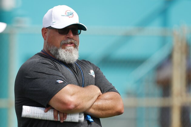 Miami Dolphins new offensive line coach Dave DeGuglielmo runs players through drills at the teams NFL football training camp, Tuesday, July 30, 2019 in Davie, Fla. (AP Photo/Wilfredo Lee)