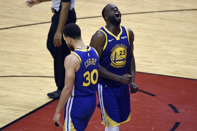 Golden State Warriors' Draymond Green (23) and Stephen Curry (30) celebrate in the closing seconds of Game 6 of the team's second-round NBA basketball playoff series against the Houston Rockets on Friday, May 10, 2019, in Houston. (AP Photo/Eric Christian Smith)