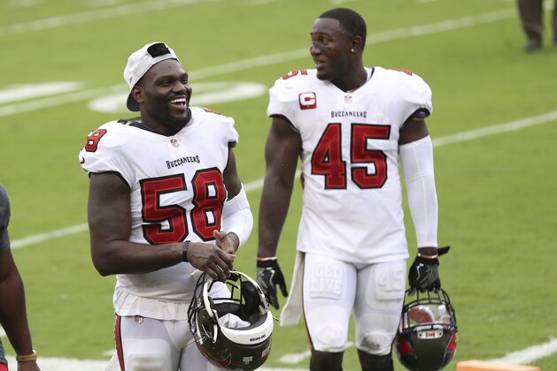 Tampa Bay Buccaneers outside linebacker Shaquil Barrett (58) and inside linebacker Devin White (45) after an NFL football game against the Los Angeles Chargers Sunday, Oct. 4, 2020, in Tampa, Fla. (AP Photo/Mark LoMoglio)