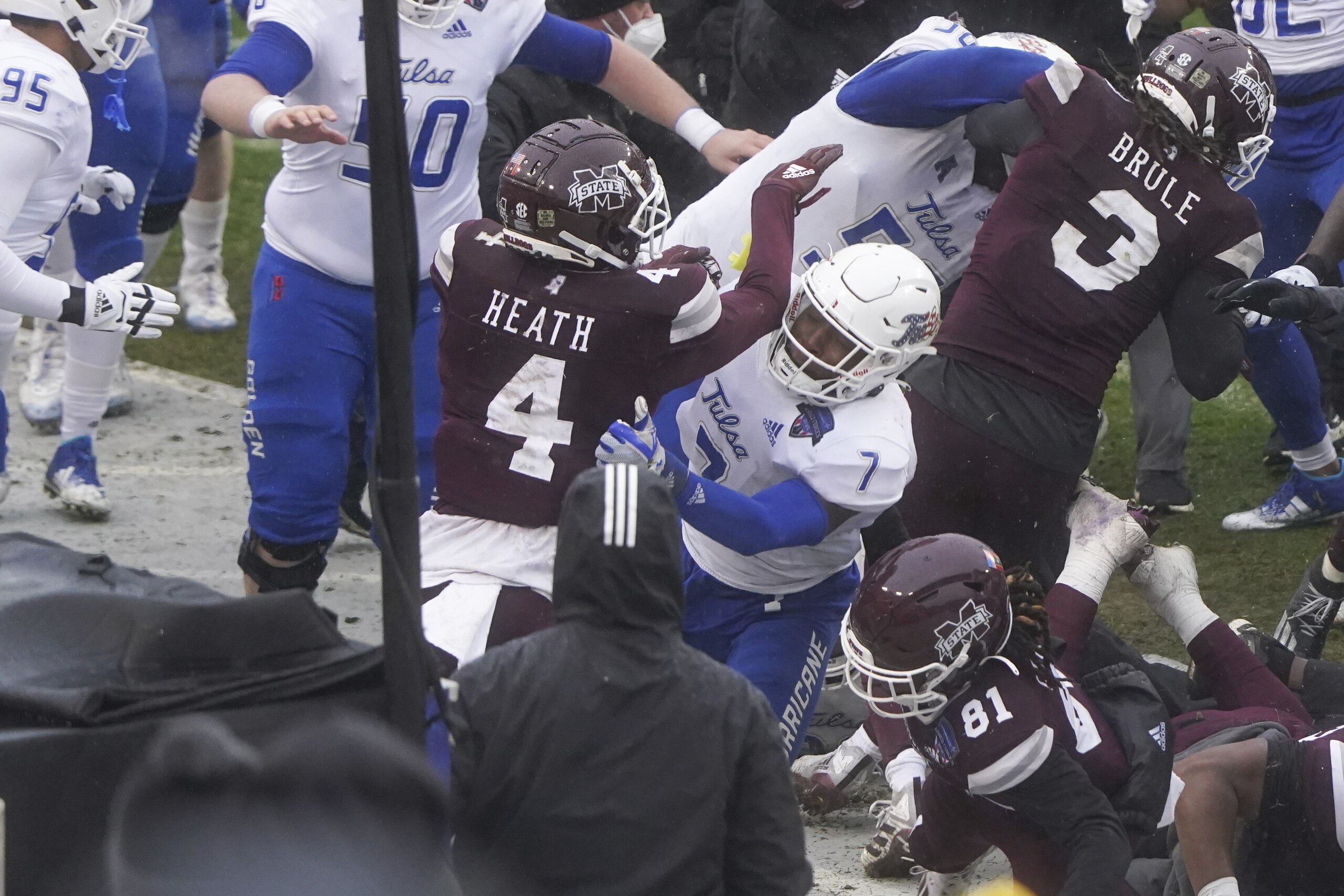 Mississippi State wide receiver Malik Heath (4) and Tulsa safety TieNeal Martin (7) fight after time runs out in Armed Forces Bowl NCAA college football game Thursday, Dec. 31, 2020, in Fort Worth, Texas. Mississippi State won 28-26. (AP Photo/Jim Cowsert)