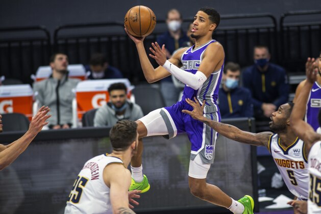 Sacramento Kings guard Tyrese Haliburton, center, drives to the basket against Denver Nuggets center Isaiah Hartenstein (25) and guard Will Barton (5) during the second half of an NBA basketball game in Sacramento, Calif., Tuesday, Dec. 29, 2020. The Kings won 125-115. (AP Photo/Hector Amezcua) Sacramento Kings guard Tyrese Haliburton, center, drives to the basket against Denver Nuggets center Isaiah Hartenstein (25) and guard Will Barton (5) during the second half of an NBA basketball game in Sacramento, Calif., Tuesday, Dec. 29, 2020. The Kings won 125-115. (AP Photo/Hector Amezcua)
