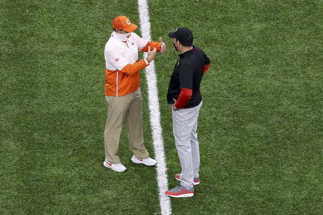 Clemson head coach Dabo Swinney, left, and Ohio State head coach Ryan Day talks before the Sugar Bowl NCAA college football game Friday, Jan. 1, 2021, in New Orleans. (AP Photo/Butch Dill)