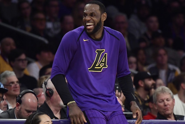 Los Angeles Lakers forward LeBron James laughs as he waits to check in to the team's NBA basketball game against the Charlotte Hornets during the second half Friday, March 29, 2019, in Los Angeles. The Lakers won 129-115. (AP Photo/Mark J. Terrill)