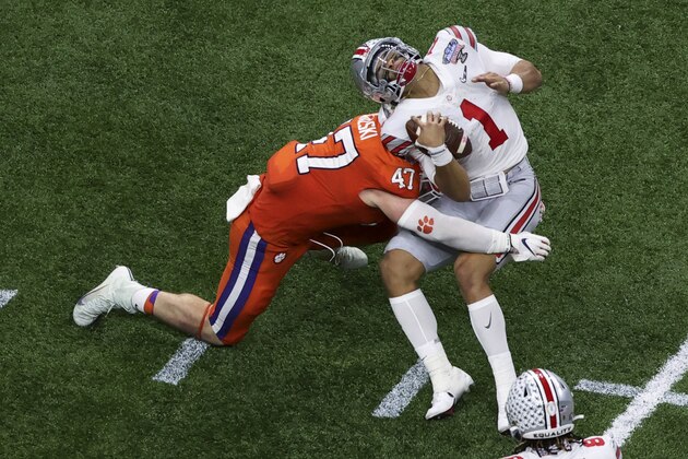 Ohio State quarterback Justin Fields gets hit by Clemson linebacker James Skalski during the first half of the Sugar Bowl NCAA college football game Friday, Jan. 1, 2021, in New Orleans. Skalski was ejected from the game for targeting. (AP Photo/Butch Dill) Ohio State quarterback Justin Fields gets hit by Clemson linebacker James Skalski during the first half of the Sugar Bowl NCAA college football game Friday, Jan. 1, 2021, in New Orleans. Skalski was ejected from the game for targeting. (AP Photo/Butch Dill)