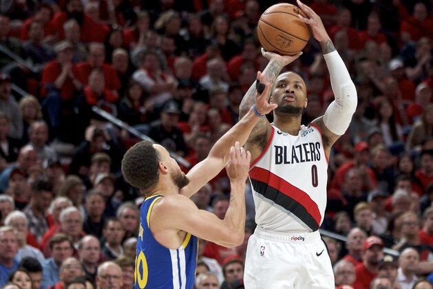 Portland Trail Blazers guard Damian Lillard, right, shoots over Golden State Warriors guard Stephen Curry during the second half of Game 4 of the NBA basketball playoffs Western Conference finals Monday, May 20, 2019, in Portland, Ore. The Warriors won 119-117 in overtime. (AP Photo/Craig Mitchelldyer)