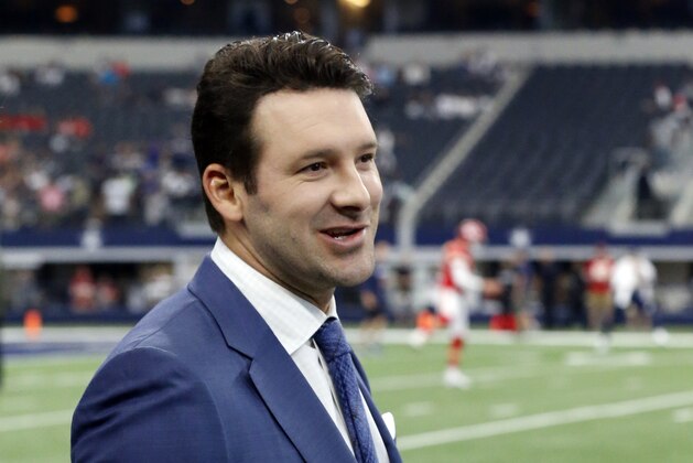 FILE - In this Nov. 5, 2017, file photo, CBS football analyst Tony Romo walks across the field during warm ups before an NFL football game between the Kansas City Chiefs and Dallas Cowboys, in Arlington, Texas.  Romo will remain with CBS as its top NFL analyst after agreeing to a record extension. CBS Sports spokeswoman Jen Sabatelle said that the network and Romo have agreed to a long-term contract.  (AP Photo/Michael Ainsworth, File)