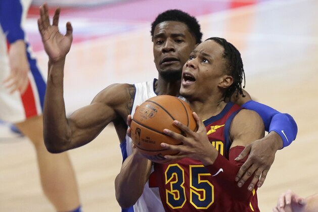 Cleveland Cavaliers guard Isaac Okoro (35) is fouled Detroit Pistons guard Josh Jackson during the second half of an NBA basketball game Saturday, Dec. 26, 2020, in Detroit. The Cavaliers won 128-119 in two overtimes. (AP Photo/Duane Burleson)