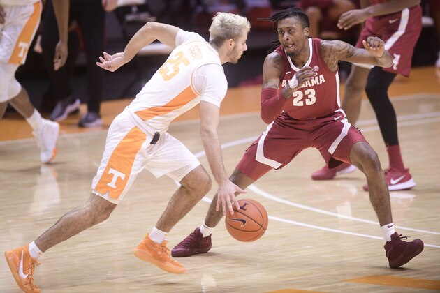 Alabama's John Senden Petty Jr. (23) defends against Tennessee's Santiago Vescovi (25) during an NCAA college basketball game Saturday, Jan. 2, 2021, in Knoxville, Tenn. (Caitie McMekin/Knoxville News Sentinel via AP, Pool)