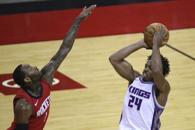 Sacramento Kings' Buddy Hield (24) looks to pass ahead ofHouston Rockets' John Wall (1) during the first quarter of an NBA basketball game Saturday, Jan. 2, 2021, in Houston. (Carmen Mandato/Pool Photo via AP)