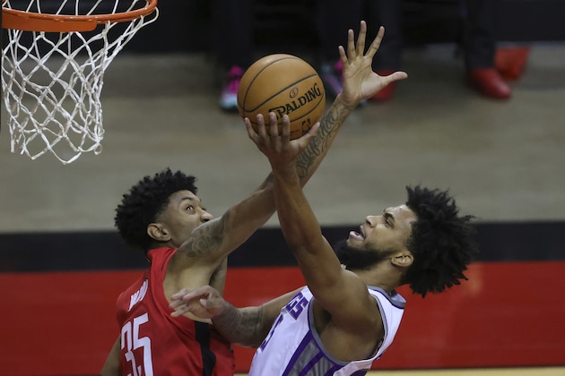 Sacramento Kings' Marvin Bagley III, right, shoots, against Houston Rockets' Christian Wood (35) during the second quarter of an NBA basketball game Saturday, Jan. 2, 2021, in Houston. (Carmen Mandato/Pool Photo via AP)