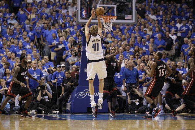 In this June 9, 2011, photo, Dallas Mavericks' Dirk Nowitzki shoots during Game 5 of the NBA Finals basketball series against the Miami Heat in Dallas. The NBA's thrilling season came with a high price tag. LeBron James' move to Miami and Nowitzki's title in Dallas couldn't hide a simple fact: Owners insisted they were losing money, perhaps $300 million this season, and weren't interested in subsidizing a system they felt guaranteed they'd keep losing more. So the NBA will lock out its players, a long-expected move that puts the 2011-12 season in jeopardy and comes as the NFL is trying to end its own work stoppage that began in March. (AP Photo/Mark Humphrey)