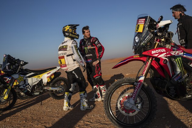 Ricky Brabec of United States, center, talks with American bikers Andrew Short, left, and Garrett Poucher before the start of stage twelve of the Dakar Rally between Haradh and Qiddiya, Saudi Arabia, Friday, Jan. 17, 2020. (AP Photo/Bernat Armangue)