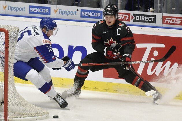 Jakub Minarik of Slovakia, left, and Barrett Hayton of Canada, in action during the 2020 IIHF World Junior Ice Hockey Championships quarterfinal match between Canada and Slovakia in Ostrava, Czech Republic, Thursday Jan. 2, 2020. (Jaroslav Ozana/CTK via AP)
