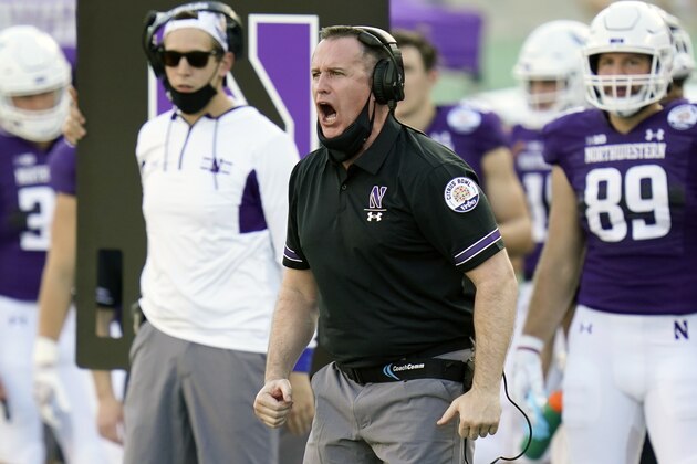Northwestern head coach Pat Fitzgerald encourages his players on the field during the second half of the Citrus Bowl NCAA college football game against Auburn, Friday, Jan. 1, 2021, in Orlando, Fla. Northwestern beat Auburn 35-19. (AP Photo/John Raoux)