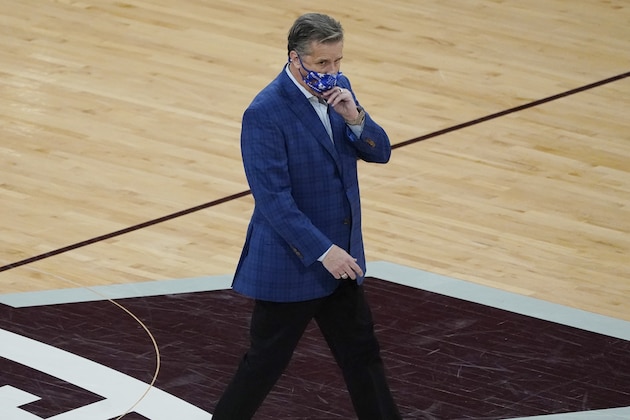 Kentucky head coach John Calipari gives his team a final look before leaving the court after being tossed out by officials in the second half of an NCAA college basketball game against Mississippi State in Starkville, Miss., Saturday, Jan. 2, 2021. (AP Photo/Rogelio V. Solis)