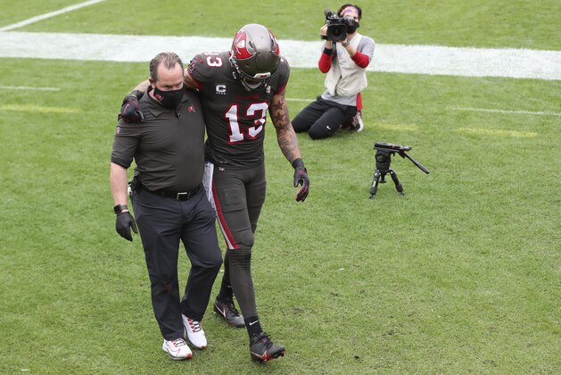 Tampa Bay Buccaneers wide receiver Mike Evans (13) is helped off the field after getting injured against the Atlanta Falcons during the first half of an NFL football game Sunday, Jan. 3, 2021, in Tampa, Fla. (AP Photo/Mark LoMoglio)