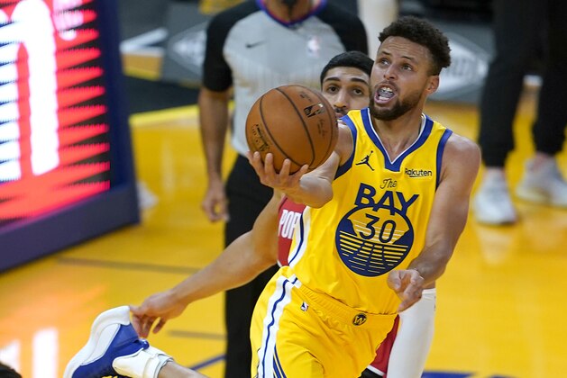 Golden State Warriors guard Stephen Curry (30) drives to the basket past Portland Trail Blazers center Enes Kanter (11) during the first half of an NBA basketball game in San Francisco, Sunday, Jan. 3, 2021. (AP Photo/Tony Avelar)