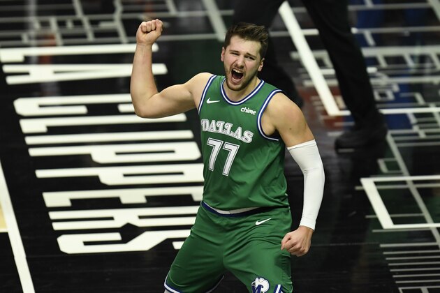 Dallas Mavericks guard Luka Doncic celebrates after scoring and drawing a foul during the first half of an NBA basketball game against the Los Angeles Clippers in Los Angeles Sunday, Dec. 27, 2020. (AP Photo/Kyusung Gong)