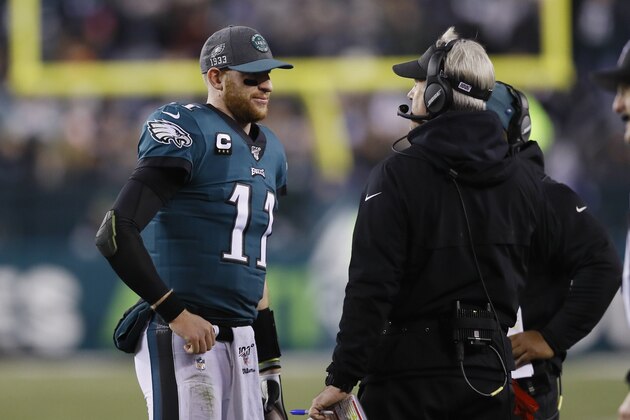 Philadelphia Eagles quarterback Carson Wentz meets with Philadelphia Eagles head coach Doug Pederson during the second half of an NFL football game against the Dallas Cowboys Sunday, Dec. 22, 2019, in Philadelphia. (AP Photo/Michael Perez)