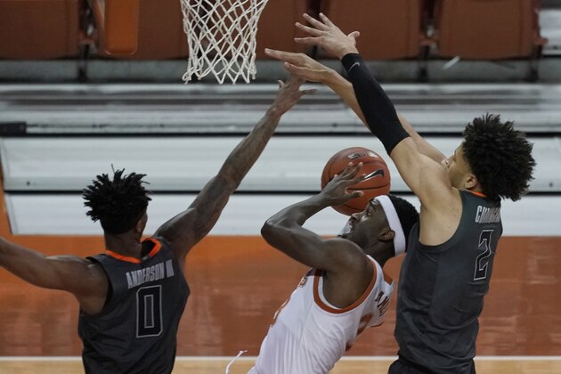 Texas' Courtney Ramey (3) shoots against Oklahoma State's Avery Anderson III (0) and Cade Cunningham (2) during the first half of an NCAA college basketball game in Austin, Texas, Sunday, Dec. 20, 2020. (AP Photo/Chuck Burton)