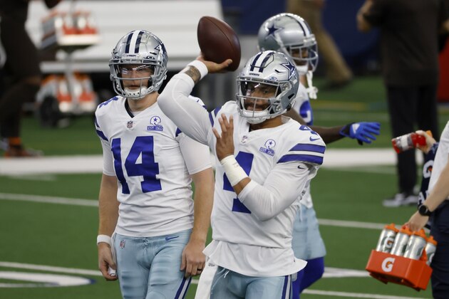 Dallas Cowboys' Dak Prescott (4) throws a pass during warmups as quarterback Andy Dalton (14) looks on before an NFL football game against the Cleveland Browns in Arlington, Texas, Sunday, Oct. 4, 2020. (AP Photo/Ron Jenkins)