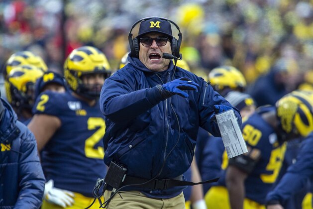 Michigan head coach Jim Harbaugh calls a timeout in the third quarter of an NCAA college football game against Ohio State in Ann Arbor, Mich., Saturday, Nov. 30, 2019. Ohio State won 56-27. (AP Photo/Tony Ding)