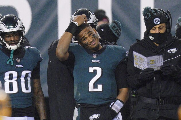 Philadelphia Eagles' Jalen Hurts scratches his head on the sideline during the second half of an NFL football game against the Washington Football Team, Sunday, Jan. 3, 2021, in Philadelphia. (AP Photo/Chris Szagola)