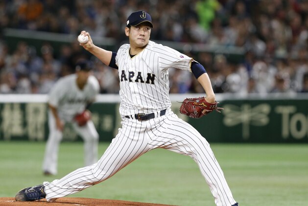Japan's starter Tomoyuki Sugano pitches against Cuba during the first inning of their second round game at the World Baseball Classic at Tokyo Dome in Tokyo, Tuesday, March 14, 2017. (AP Photo/Toru Takahashi)