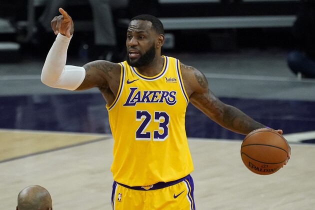 Los Angeles Lakers forward LeBron James (23) calls a play against the Phoenix Suns during the first half of a preseason NBA basketball game, Friday, Dec. 18, 2020, in Phoenix, Ariz. (AP Photo/Matt York)